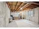 Unfinished basement with concrete walls and exposed wooden ceiling beams at 2934 Braeburn Way, Highlands Ranch, CO 80126