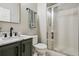 Updated bathroom featuring a sleek vanity, marble countertop, and glass-enclosed shower at 2934 Braeburn Way, Highlands Ranch, CO 80126