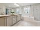Bright bathroom with double vanity, soaking tub, and separate glass shower at 2934 Braeburn Way, Highlands Ranch, CO 80126