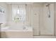 Relaxing bathroom featuring a soaking tub and glass-enclosed shower at 2934 Braeburn Way, Highlands Ranch, CO 80126