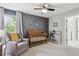 Cozy carpeted bedroom with a wood crib and modern ceiling fan at 2934 Braeburn Way, Highlands Ranch, CO 80126