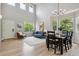 Spacious open concept living and dining area with tall windows at 2934 Braeburn Way, Highlands Ranch, CO 80126