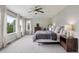Spacious main bedroom featuring natural light, plush carpet, and neutral decor at 2934 Braeburn Way, Highlands Ranch, CO 80126