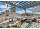 A back deck has an outdoor dining area with comfortable seating and string lights for ambiance at 5880 Beeler Ct, Denver, CO 80238
