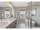 Modern bathroom with double sinks, a standalone soaking tub, and a glass-enclosed shower for a spa-like experience at 5880 Beeler Ct, Denver, CO 80238