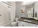 Bright bathroom featuring white herringbone tile, white vanity and chrome fixtures at 5880 Beeler Ct, Denver, CO 80238