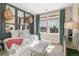 Stylish bedroom featuring unique decor, a comfortable daybed, and ample natural light at 5880 Beeler Ct, Denver, CO 80238
