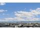 Scenic view of the Denver skyline and Rocky Mountains from the neighborhood rooftops on a sunny, partly cloudy day at 5880 Beeler Ct, Denver, CO 80238