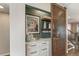 Convenient coffee bar with open and closed storage, next to a wood slat barn door at 5880 Beeler Ct, Denver, CO 80238