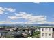 Expansive community view with city skyline and mountain backdrop under a sunny, blue sky at 5880 Beeler Ct, Denver, CO 80238