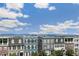 A street view showcases colorful townhouses with landscaped front yards under a blue sky at 5880 Beeler Ct, Denver, CO 80238