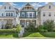 Charming two-story home featuring a covered front porch, well-manicured lawn, and attractive architectural details at 5880 Beeler Ct, Denver, CO 80238