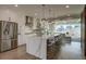 Bright, modern kitchen with a waterfall island, stainless steel appliances, and open access to the living space at 5880 Beeler Ct, Denver, CO 80238