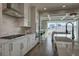 Bright, open kitchen with stainless steel appliances and a gas cooktop stove, perfect for cooking and entertaining at 5880 Beeler Ct, Denver, CO 80238