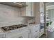 Chef's kitchen with stainless steel appliances, tiled backsplash, and modern cabinetry at 5880 Beeler Ct, Denver, CO 80238