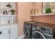 Well-organized laundry room with modern washer and dryer, a sink, and stylish decor at 5880 Beeler Ct, Denver, CO 80238