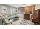 Cozy living room with unique wood accent wall, stylish decor, and eye-catching patterned tile flooring at 5880 Beeler Ct, Denver, CO 80238