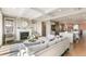 Bright living room with fireplace, hardwood floors, and an open layout leading to the kitchen at 5880 Beeler Ct, Denver, CO 80238