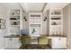 Home office space featuring custom built-in shelving, work desk, and stylish decor at 5880 Beeler Ct, Denver, CO 80238