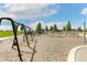Community playground featuring swings, climbing structures, and a soft, engineered wood fiber surface at 5880 Beeler Ct, Denver, CO 80238