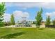 Community pool area featuring a waterslide, well-manicured lawn, and covered picnic areas at 5880 Beeler Ct, Denver, CO 80238