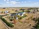 Expansive aerial view of a home with a large yard, garden, shed, and white fencing in a rural neighborhood setting at 29850 E 167Th Pl, Brighton, CO 80603