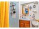 Bathroom featuring blue tile, a shower with a yellow curtain, and a wooden vanity at 2421 N York St, Denver, CO 80205