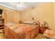 A cozy bedroom featuring a tufted headboard, colorful quilt, and warm, inviting decor at 2421 N York St, Denver, CO 80205