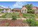 View of a quaint home with brick stairs, a front porch awning, and an overgrown front yard at 2421 N York St, Denver, CO 80205