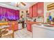 A charming kitchen features appliances, including white tile floors, and wooden accents at 2421 N York St, Denver, CO 80205