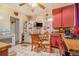 A cozy eat-in kitchen with white appliances and a small dining table perfect for meals at 2421 N York St, Denver, CO 80205