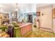 Comfortable living room with large windows, a cozy fireplace, and plush green furniture at 2421 N York St, Denver, CO 80205