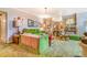 A comfortable living room features plush green furnishings, decorative lamps and green carpet at 2421 N York St, Denver, CO 80205