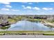 Scenic aerial view of the neighborhood lake, clubhouse, and lush green spaces creating a picturesque community setting at 27381 E Lakeview Dr, Aurora, CO 80016