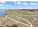 Aerial view of walking trails and a serene lake, providing scenic outdoor recreation opportunities for residents at 27381 E Lakeview Dr, Aurora, CO 80016