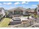 Stunning backyard with a tiered patio, fireplace, pergola, and lush lawn is perfect for outdoor entertaining at 27381 E Lakeview Dr, Aurora, CO 80016