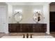 Bathroom vanity featuring dual sinks, wood cabinets, and modern fixtures at 27381 E Lakeview Dr, Aurora, CO 80016