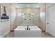 A well-lit bathroom featuring a modern bathtub, glass shower, and sleek fixtures at 27381 E Lakeview Dr, Aurora, CO 80016