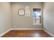 Cozy bedroom with hardwood floors, a view, and minimalist decor at 27381 E Lakeview Dr, Aurora, CO 80016