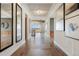 Elegant foyer with tray ceiling, herringbone wood floors and walls adorned with decorative mirrors and paintings at 27381 E Lakeview Dr, Aurora, CO 80016