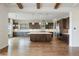 Modern kitchen with dark wood cabinets, stainless steel appliances, and a large center island with marble countertops at 27381 E Lakeview Dr, Aurora, CO 80016