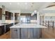 Open kitchen featuring dark wood cabinets, quartz countertops, stainless steel appliances and pendant lighting at 27381 E Lakeview Dr, Aurora, CO 80016