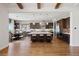 Modern kitchen with a large center island, stainless steel appliances, dark wood cabinets, and adjacent dining area at 27381 E Lakeview Dr, Aurora, CO 80016
