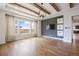 Bright living room featuring hardwood floors, large windows with views, and stylish light fixture at 27381 E Lakeview Dr, Aurora, CO 80016