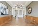 Elegant living room with hardwood floors, decorative artwork, and wainscoting, creating a sophisticated atmosphere at 27381 E Lakeview Dr, Aurora, CO 80016
