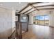 An open living space with fireplace, exposed beams, walkout to patio, and staircase with metal railings at 27381 E Lakeview Dr, Aurora, CO 80016