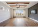 Bright living room with wood floors, beamed ceilings, and a large window with views at 27381 E Lakeview Dr, Aurora, CO 80016