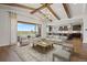 Bright living room with beamed ceilings, seamless indoor/outdoor flow, and views into the modern kitchen at 27381 E Lakeview Dr, Aurora, CO 80016