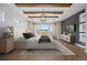 Stunning main bedroom featuring wood beam details, tray ceiling, and a serene view of the outdoors at 27381 E Lakeview Dr, Aurora, CO 80016