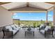Covered outdoor patio with comfortable seating and stunning panoramic views of the surrounding landscape at 27381 E Lakeview Dr, Aurora, CO 80016